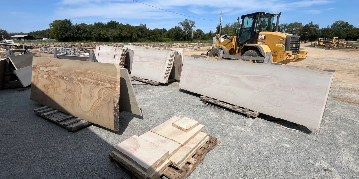 Large sandstone bridge slabs with loader
