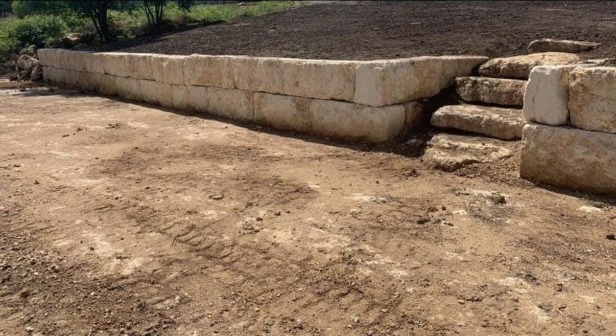 Finished limestone block retaining wall with steps
