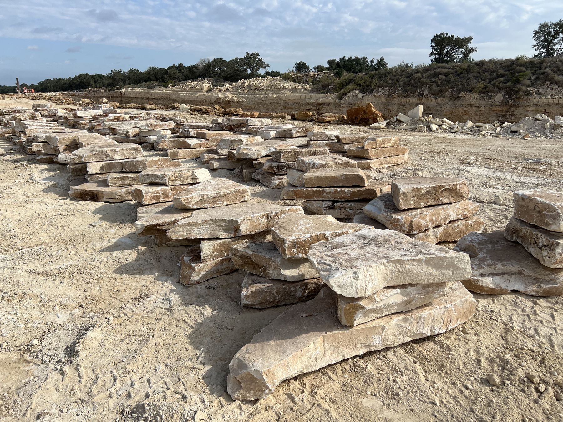 Rows of quarried Texas limestone boulders ready to load