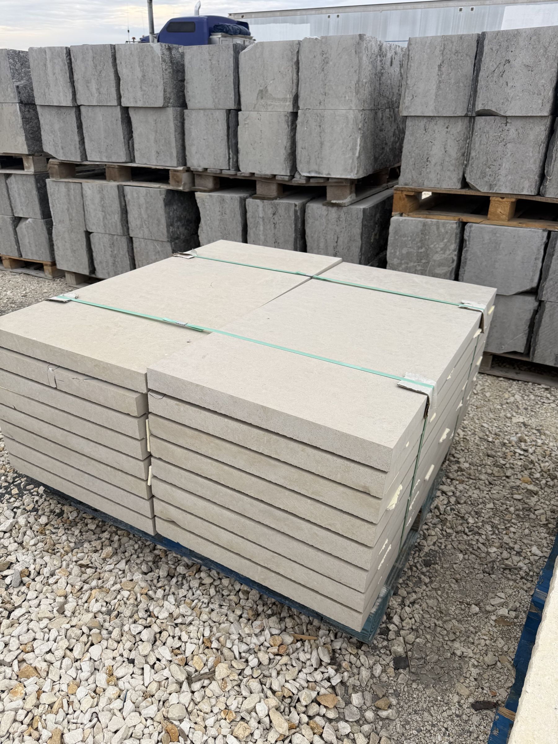 Sawn limestone slabs and caps stacked on pallets