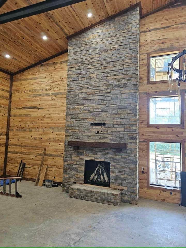 Floor-to-ceiling stone veneer fireplace